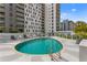 Community pool with lounge chairs and umbrellas, perfect for relaxation at 199 Dali Blvd # 2, St Petersburg, FL 33701