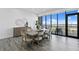 Bright dining room with wood floors, large windows offering panoramic views, and a modern table set at 199 Dali Blvd # 2, St Petersburg, FL 33701