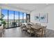 Bright dining room with wood floors, large windows offering panoramic views, and a modern table set at 199 Dali Blvd # 2, St Petersburg, FL 33701