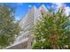 Beautiful, modern high-rise condo building with balconies and vibrant landscaping at 199 Dali Blvd # 2, St Petersburg, FL 33701
