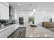 Modern kitchen featuring stainless steel appliances, granite counters, white cabinetry and tile floors at 199 Dali Blvd # 2, St Petersburg, FL 33701