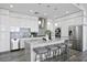 Modern kitchen with white cabinets, stainless steel appliances, gray countertops, and stylish bar seating at 199 Dali Blvd # 2, St Petersburg, FL 33701