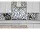 Modern kitchen featuring sleek white cabinets, a stylish backsplash, and stainless steel appliances at 199 Dali Blvd # 2, St Petersburg, FL 33701