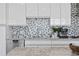 Bright kitchen with stainless steel appliances, stone countertops, a stylish backsplash, and ample storage space at 199 Dali Blvd # 2, St Petersburg, FL 33701