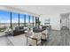Inviting living space with comfortable sofas, light colored chairs, city view windows, and tiled flooring at 199 Dali Blvd # 2, St Petersburg, FL 33701