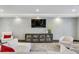 Inviting living room with comfortable seating, a large TV, and a decorative bookcase for a cozy and stylish space at 199 Dali Blvd # 2, St Petersburg, FL 33701
