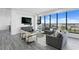 Bright living room featuring expansive windows, gray sofas, light colored chairs and stylish decor at 199 Dali Blvd # 2, St Petersburg, FL 33701