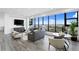 Bright living room with gray sofas, modern decor, expansive windows with city views and tile flooring at 199 Dali Blvd # 2, St Petersburg, FL 33701