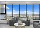 Bright living room showcasing city views, gray sofas, stylish decor, and expansive picture windows at 199 Dali Blvd # 2, St Petersburg, FL 33701