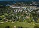 Expansive aerial view of a golf course community featuring lush greens, mature trees, and nearby shopping at 209 S Greenfield Ave, Temple Terrace, FL 33617