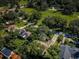 An aerial view of a home surrounded by lush greenery and a golf course community at 209 S Greenfield Ave, Temple Terrace, FL 33617