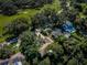 Aerial view showcases the home, positioned near a golf course, surrounded by lush greenery at 209 S Greenfield Ave, Temple Terrace, FL 33617