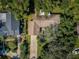 Aerial view of a property with a long driveway, mature landscaping, and partial view of the roof at 209 S Greenfield Ave, Temple Terrace, FL 33617
