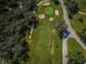 An aerial view of a lush green golf course featuring a sand trap at 209 S Greenfield Ave, Temple Terrace, FL 33617