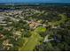 Expansive aerial view of a lush golf course community, featuring verdant greens, mature trees, and well-maintained homes at 209 S Greenfield Ave, Temple Terrace, FL 33617