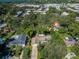 An aerial view of a single Gathering home surrounded by lush greenery and mature trees at 209 S Greenfield Ave, Temple Terrace, FL 33617