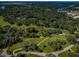 Picturesque aerial view of a golf course surrounded by lush trees and homes, offering a serene and desirable community at 209 S Greenfield Ave, Temple Terrace, FL 33617
