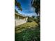 The exterior of a green house featuring a spacious yard with green grass at 209 S Greenfield Ave, Temple Terrace, FL 33617