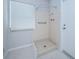 Bathroom featuring a walk-in shower with neutral walls and a window at 209 S Greenfield Ave, Temple Terrace, FL 33617