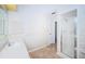 Neutral bathroom featuring a glass-enclosed shower and a vanity with storage at 209 S Greenfield Ave, Temple Terrace, FL 33617