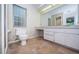 Neutral bathroom featuring a toilet, vanity, and a large mirror above the sink at 209 S Greenfield Ave, Temple Terrace, FL 33617