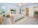 Bright bedroom with a large window, a bed with soft linens, and access to a walk-in closet at 209 S Greenfield Ave, Temple Terrace, FL 33617