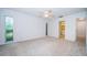 Bright bedroom featuring neutral carpet, natural light, and an ensuite bathroom at 209 S Greenfield Ave, Temple Terrace, FL 33617