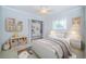 Bright bedroom features a ceiling fan, a closet, and a charming display of stuffed animals at 209 S Greenfield Ave, Temple Terrace, FL 33617