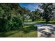 Lush green landscaping and mature trees line the street leading to the property at 209 S Greenfield Ave, Temple Terrace, FL 33617