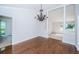 This dining room features beautiful wood floors and a decorative chandelier, creating a warm and inviting space at 209 S Greenfield Ave, Temple Terrace, FL 33617