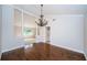 Inviting dining area with hardwood floors, pillars, and a decorative chandelier for memorable gatherings at 209 S Greenfield Ave, Temple Terrace, FL 33617
