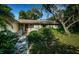 Charming home exterior with a well-maintained lawn and mature trees at 209 S Greenfield Ave, Temple Terrace, FL 33617