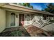 Inviting front entrance featuring a stylish door and manicured landscaping at 209 S Greenfield Ave, Temple Terrace, FL 33617