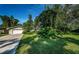 A well-maintained home featuring a two-car garage, lush landscaping, and a neatly manicured front lawn at 209 S Greenfield Ave, Temple Terrace, FL 33617