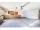 Spacious garage with ample space, storage shelves, and access to yard at 209 S Greenfield Ave, Temple Terrace, FL 33617