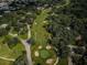 Scenic aerial shot of a well-manicured golf course, highlighting the green fairway, sand traps, and surrounding trees at 209 S Greenfield Ave, Temple Terrace, FL 33617