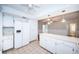 Open-concept kitchen with white cabinets, a ceiling fan, and connection to the adjacent living area at 209 S Greenfield Ave, Temple Terrace, FL 33617
