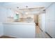 Bright kitchen featuring white cabinetry, tile backsplash, and modern appliances, perfect for cooking enthusiasts at 209 S Greenfield Ave, Temple Terrace, FL 33617