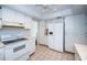 Spacious kitchen with white cabinets, a built-in refrigerator, and tile flooring for easy maintenance at 209 S Greenfield Ave, Temple Terrace, FL 33617