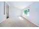 Spacious living room featuring neutral walls, carpet, and large window at 209 S Greenfield Ave, Temple Terrace, FL 33617