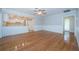 Bright living room with hardwood floors, wainscoting, and seamless access to the adjacent kitchen at 209 S Greenfield Ave, Temple Terrace, FL 33617