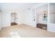 Spacious living room with neutral carpet, white walls, and arched doorway to adjacent room at 209 S Greenfield Ave, Temple Terrace, FL 33617