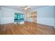 Bright living room featuring hardwood floors, wainscoting, and access to a sunroom and the kitchen at 209 S Greenfield Ave, Temple Terrace, FL 33617