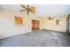 Sunroom with carpet, ceiling fans, windows, and sliding doors leading to an adjacent room at 209 S Greenfield Ave, Temple Terrace, FL 33617