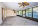 Spacious sunroom with ceiling fans, sliding glass doors, and large windows with exterior view at 209 S Greenfield Ave, Temple Terrace, FL 33617