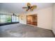 Sunroom features large windows, a ceiling fan, and a view of the interior through sliding glass doors at 209 S Greenfield Ave, Temple Terrace, FL 33617