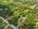 Aerial view of the large, wooded property showcasing the lot boundaries and the home's location at 2112 33Rd Se St, Ruskin, FL 33570