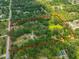 This is an aerial view of the property showing the boundary, pond, and houses at 2112 33Rd Se St, Ruskin, FL 33570