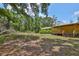 Exterior view of the house showcasing the yard and surrounding trees at 2112 33Rd Se St, Ruskin, FL 33570