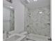 Bright bathroom features stylish marble-like tile, a shower-tub combo, and white vanity at 2112 33Rd Se St, Ruskin, FL 33570